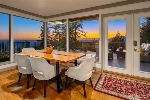 a view of a dining room with a table and chairs