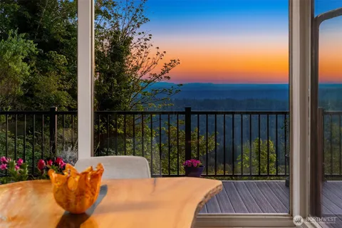 a view of a balcony with floor to ceiling window and wooden fence
