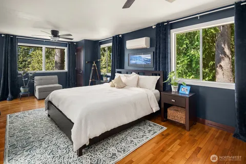 a bedroom with a large bed and a window