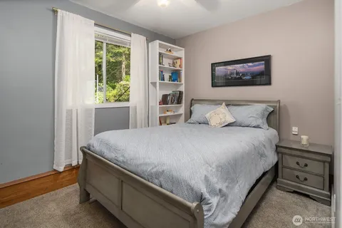 a bedroom with a bed and a window