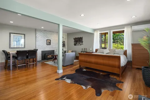 a bedroom with furniture and a wooden floor
