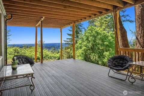 a balcony with furniture and potted plants