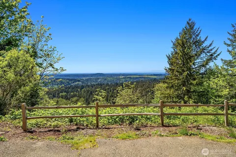a view of a yard with wooden fence
