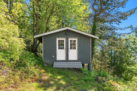 a front view of a house with a garden