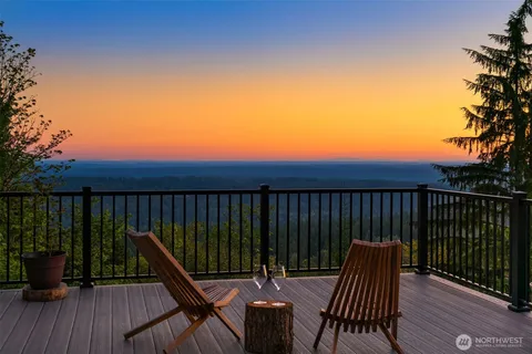a view of balcony with wooden floor and seating space