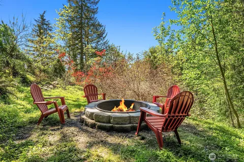 a backyard of a house with table and chairs