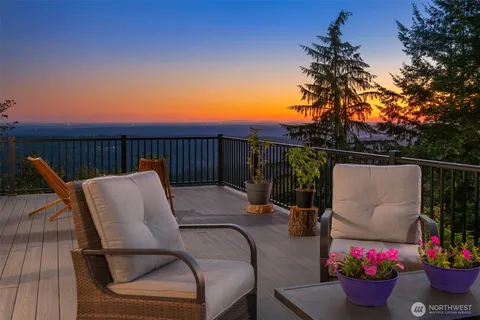 a balcony with lots of potted plants