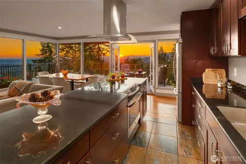 a kitchen with stainless steel appliances granite countertop sink stove and cabinets