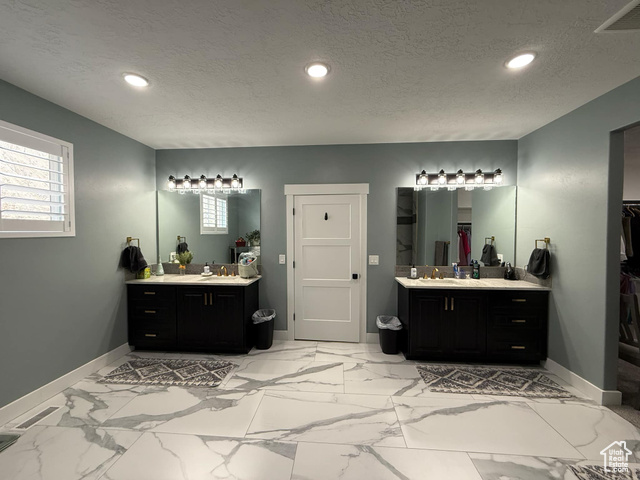 1240 West 2360 North Helper, UT 84526 - Photo 39 of 79 Bathroom with a textured ceiling, visible vents, baseboards, recessed lighting, and two vanities