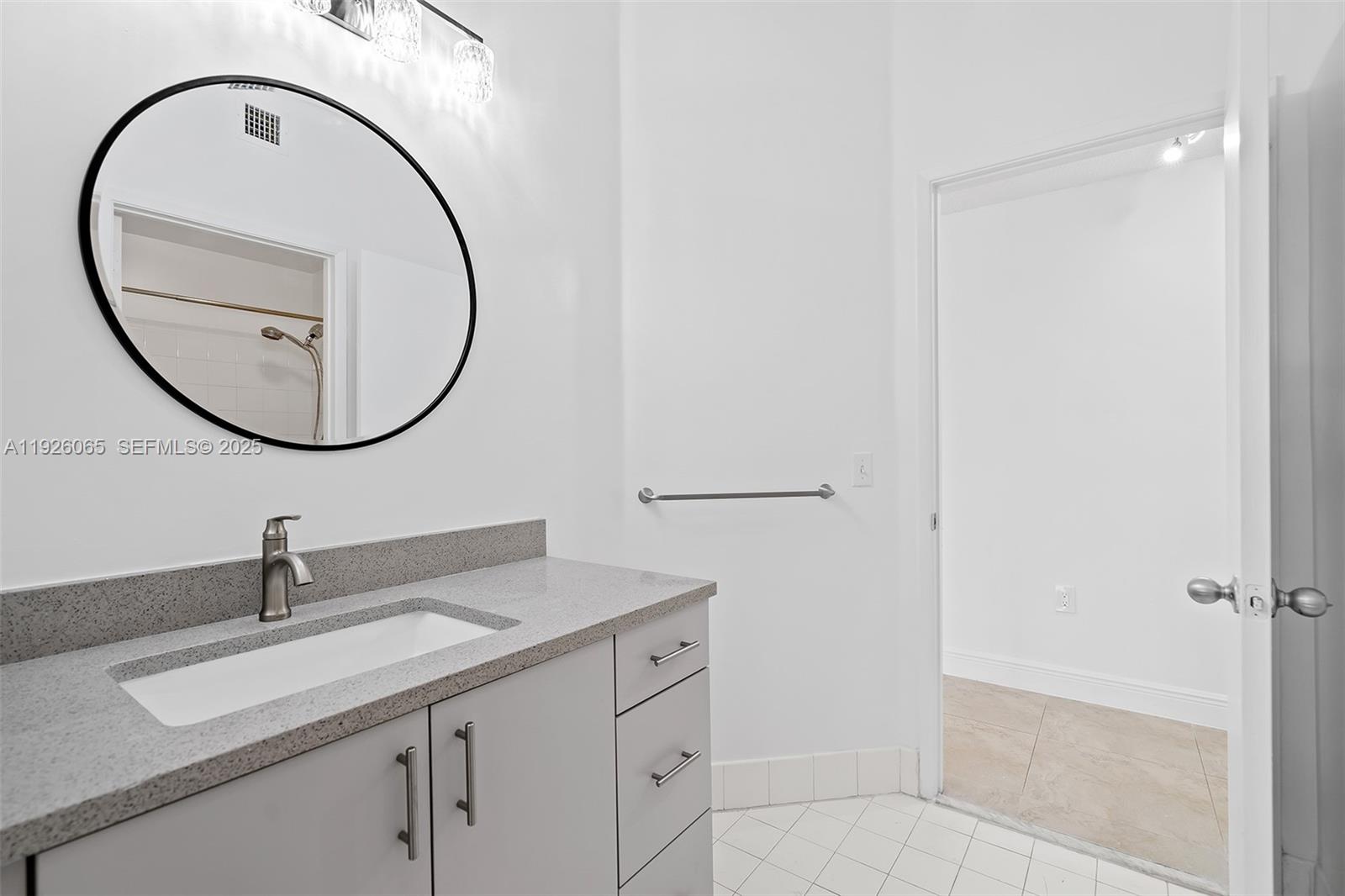 6992 Southwest 39th Street, Unit I302 Davie, FL 33314 - Photo 18 of 23 a bathroom with a sink and a mirror