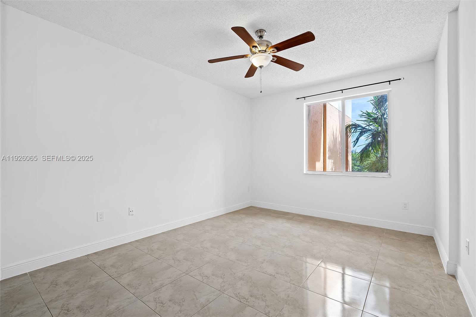 6992 Southwest 39th Street, Unit I302 Davie, FL 33314 - Photo 19 of 23 an empty room with windows and ceiling fan