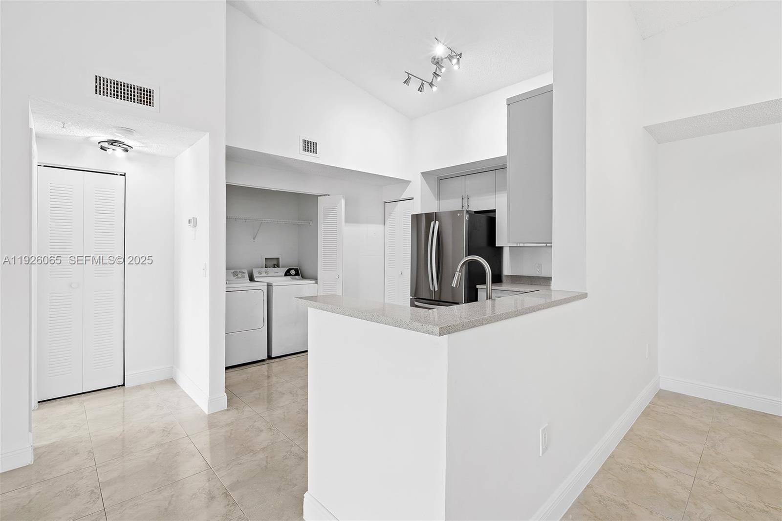 6992 Southwest 39th Street, Unit I302 Davie, FL 33314 - Photo 6 of 23 a view of a bathroom with a sink and mirror