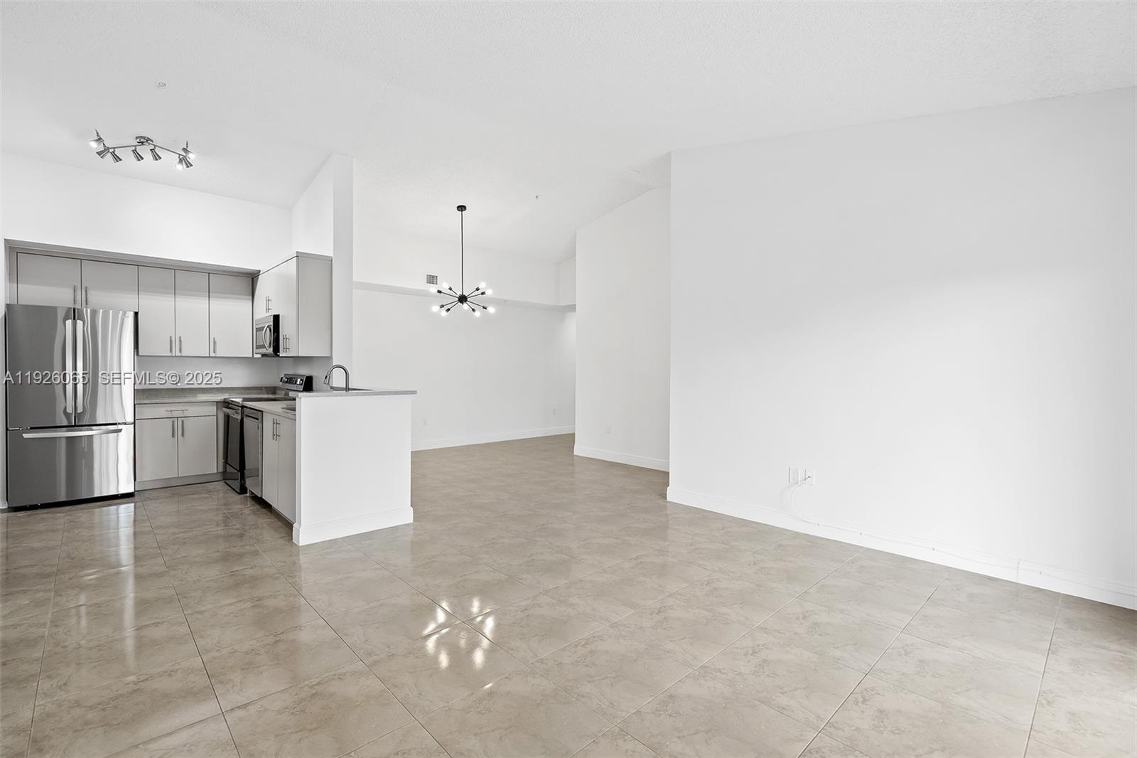 6992 Southwest 39th Street, Unit I302 Davie, FL 33314 - Photo 7 of 23 a kitchen with cabinets and stainless steel appliances