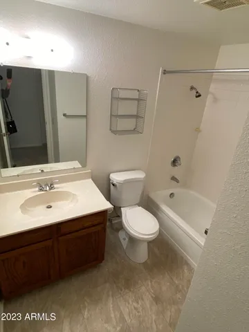 a bathroom with a sink toilet a mirror and shower