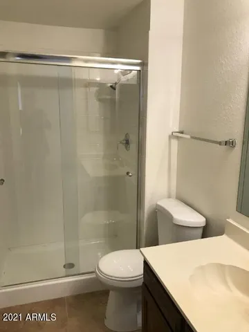 a bathroom with a shower and a toilet