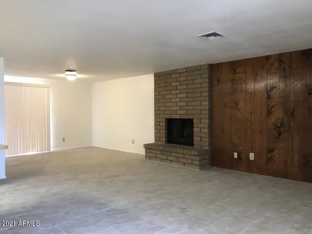 a view of an empty room with a fireplace