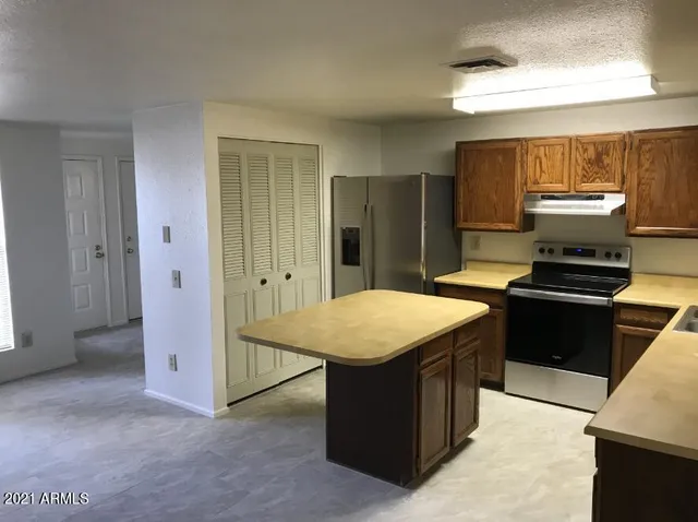 a kitchen with a stove a refrigerator and a stove