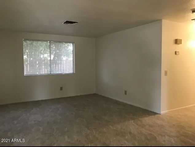 an empty room with an empty space and windows