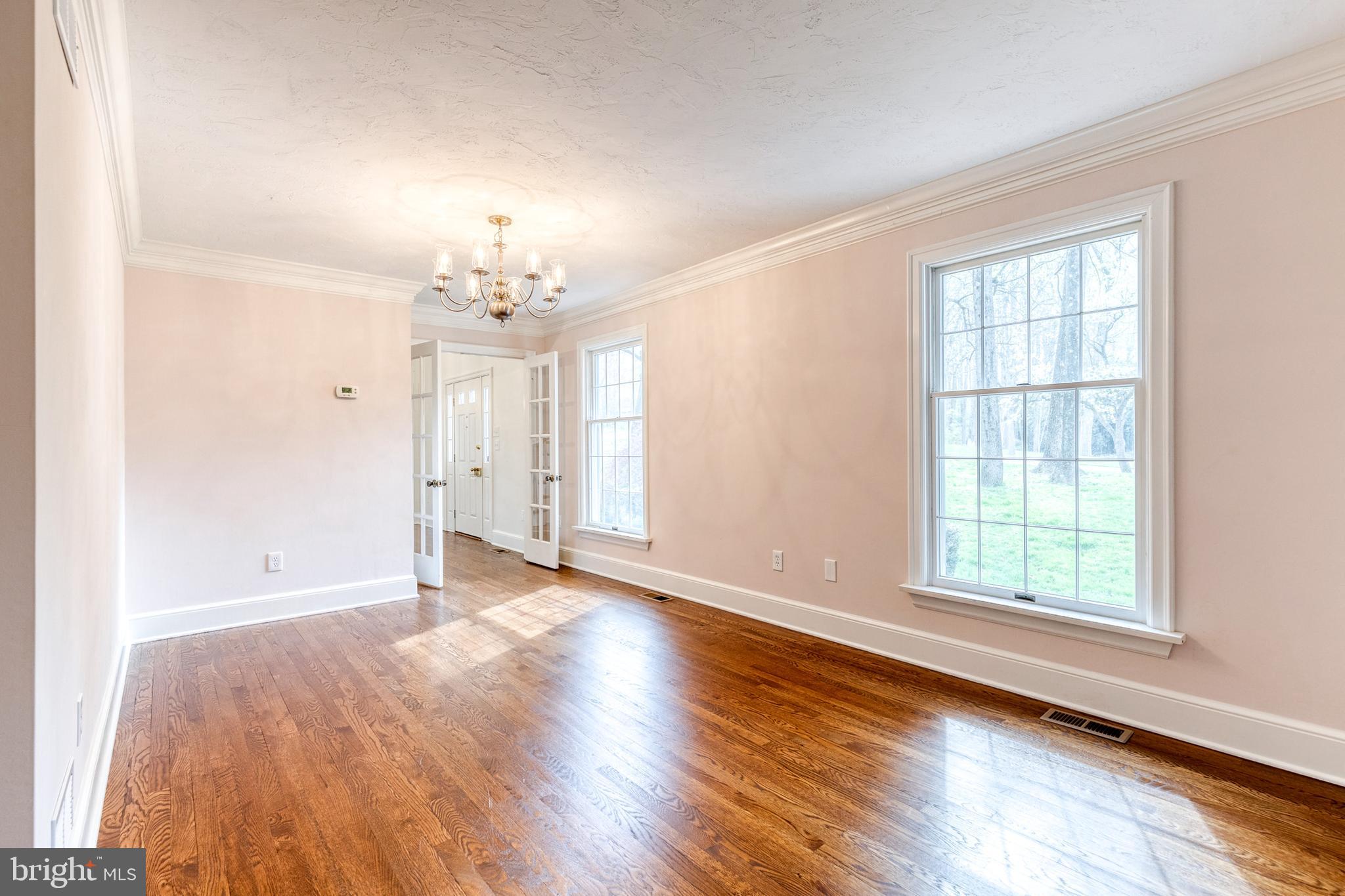 1216 Bonaire Road Forest Hill, MD 21050 - Photo 29 of 71 an empty room with wooden floor chandelier and windows