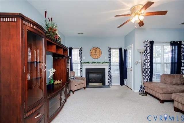 a living room with furniture and a fireplace