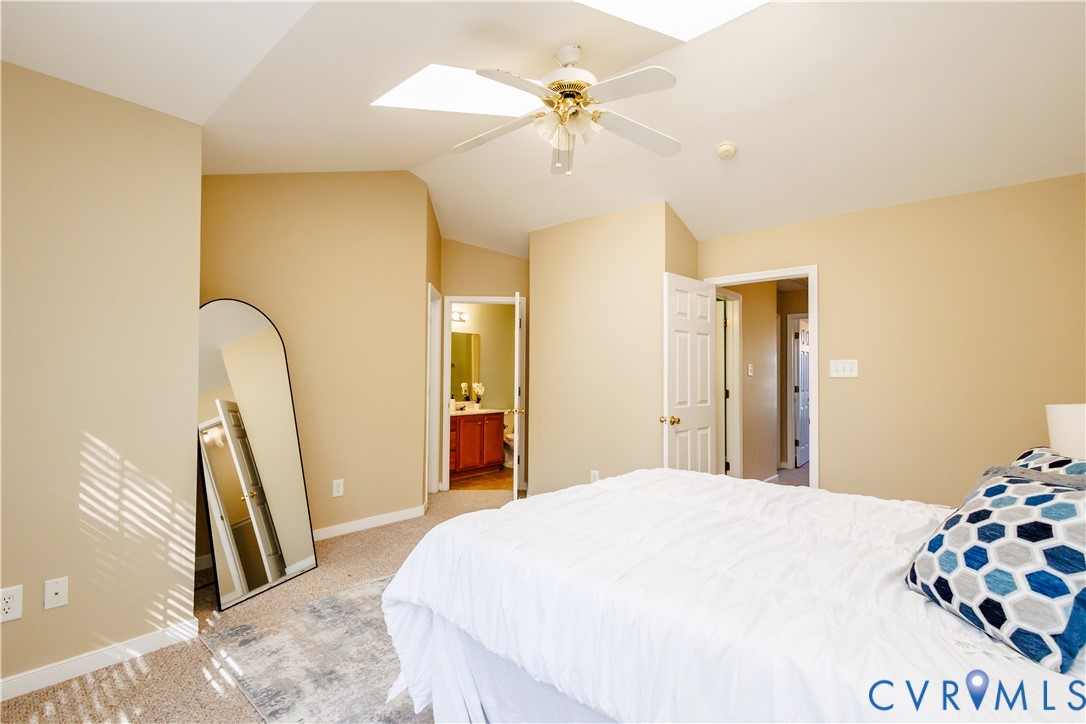 405 Hollybrook Ridge Lane Richmond, VA 23223 - Photo 23 of 37 a bedroom with a bed and a chandelier