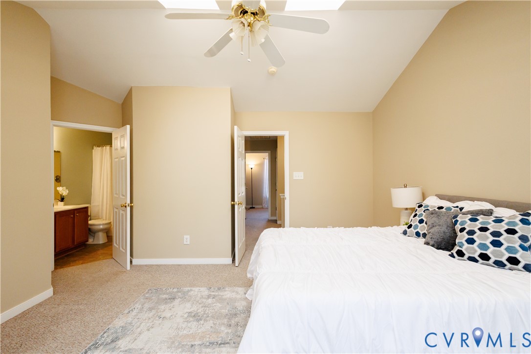 405 Hollybrook Ridge Lane Richmond, VA 23223 - Photo 24 of 37 a bedroom with a bed and a chandelier