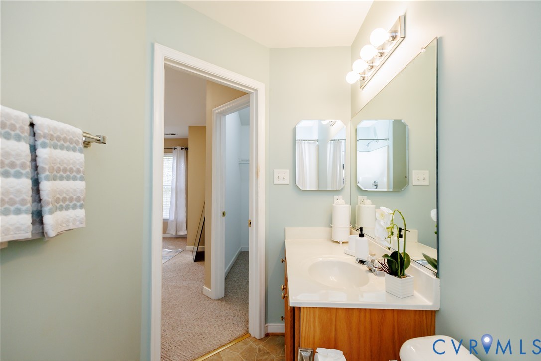 405 Hollybrook Ridge Lane Richmond, VA 23223 - Photo 27 of 37 a bathroom with a sink and mirror