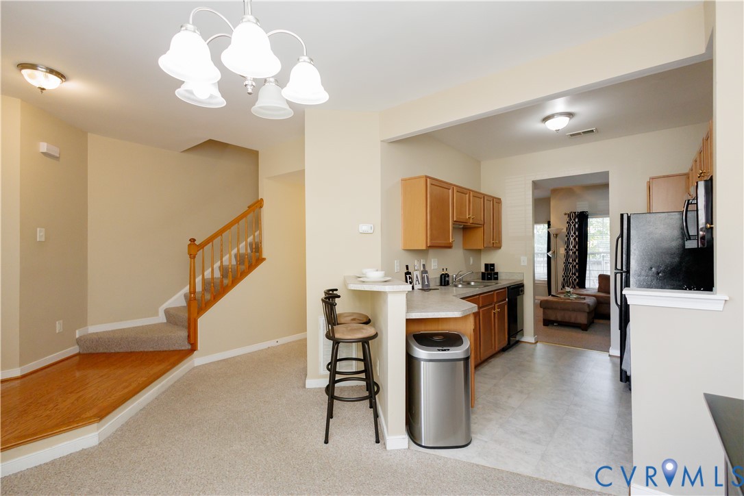405 Hollybrook Ridge Lane Richmond, VA 23223 - Photo 3 of 37 a view of kitchen with furniture and a chandelier