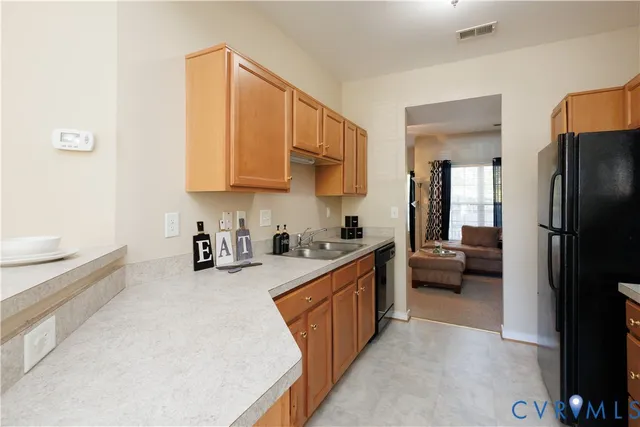 a kitchen with a refrigerator a sink and a stove