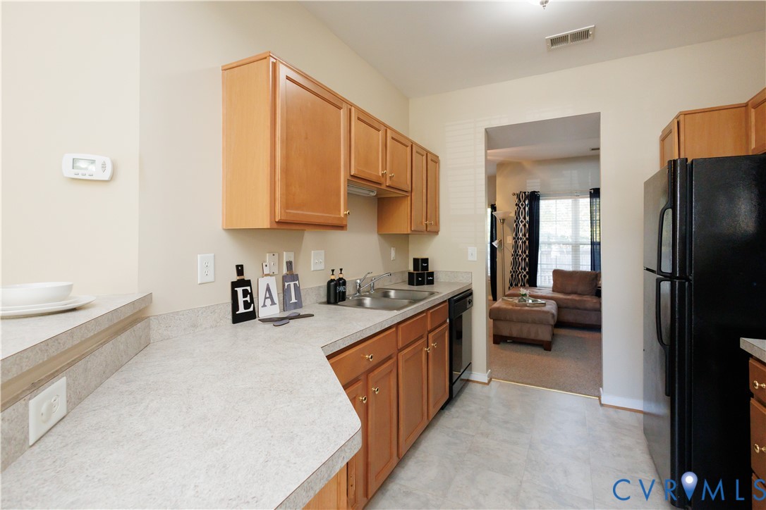 405 Hollybrook Ridge Lane Richmond, VA 23223 - Photo 8 of 37 a kitchen with a refrigerator a sink and a stove