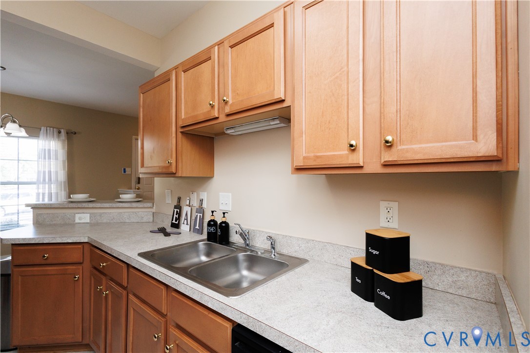 405 Hollybrook Ridge Lane Richmond, VA 23223 - Photo 9 of 37 a kitchen with stainless steel appliances granite countertop a sink dishwasher stove and cabinets with wooden floor