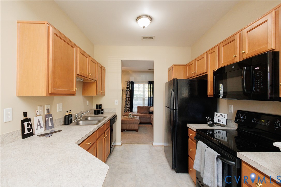 405 Hollybrook Ridge Lane Richmond, VA 23223 - Photo 10 of 37 a kitchen with stainless steel appliances granite countertop a refrigerator stove and sink