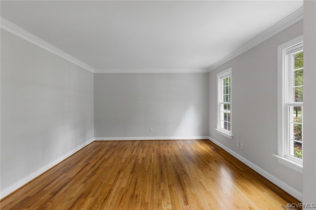 507 Rivers Bend Circle Chester, VA 23836 - Photo 4 of 41 an empty room with wooden floor and windows