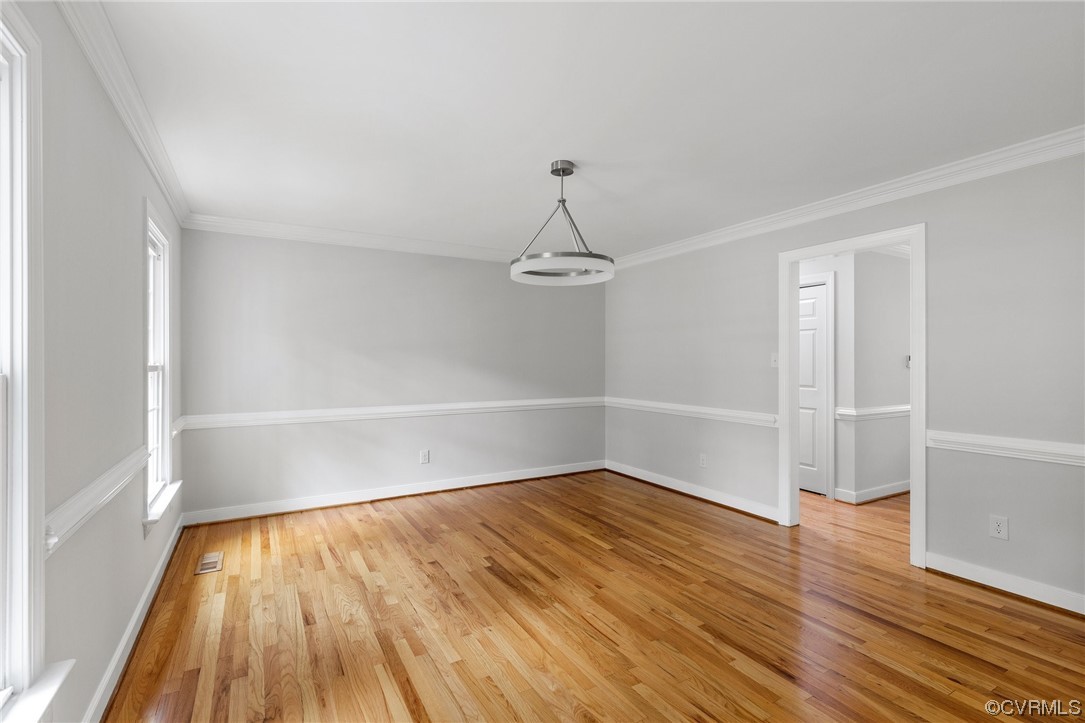507 Rivers Bend Circle Chester, VA 23836 - Photo 7 of 41 an empty room with wooden floor and white walls