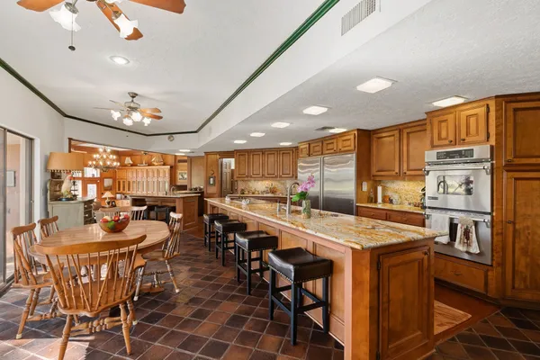 a kitchen with a stove a sink and a refrigerator