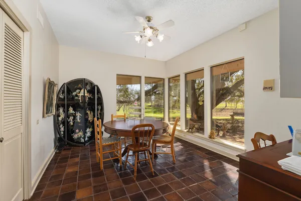 a room with pool table and glass windows