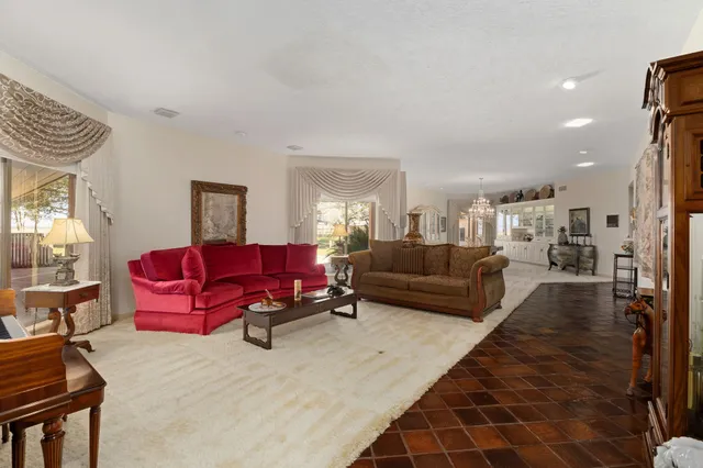 a kitchen with sink refrigerator and large window