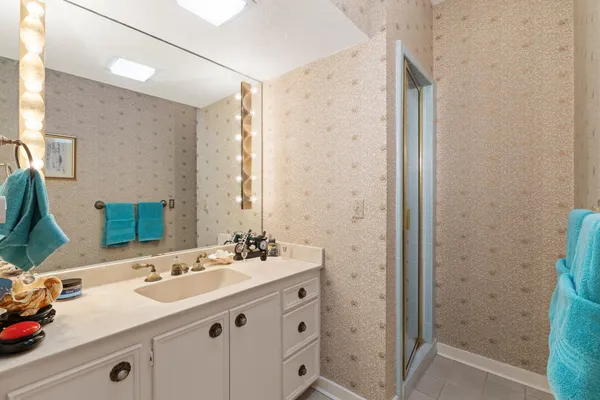 a bathroom with a sink double vanity mirror and a bathtub