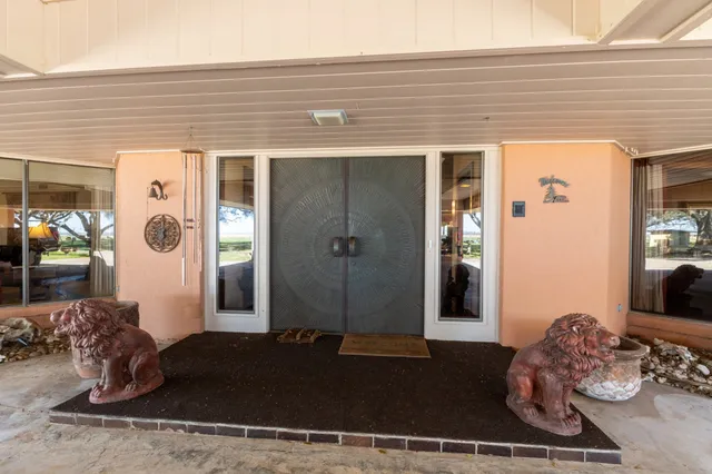 a living room with fireplace furniture and a rug