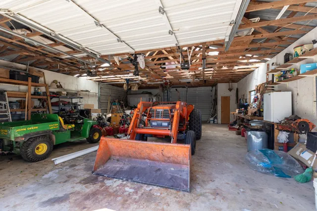 a living room with furniture a table and kitchen view