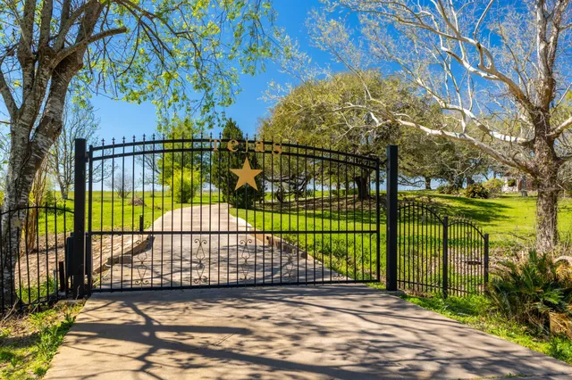 a view of a hallway with wooden floor and stairs