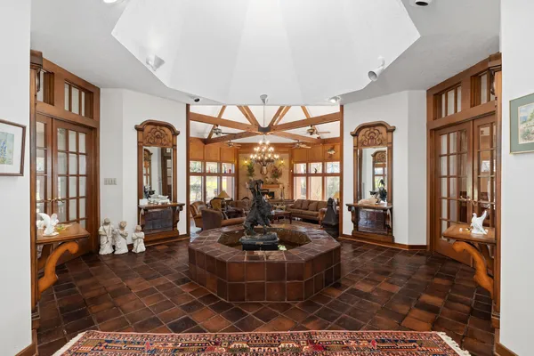 a living room with furniture ceiling fan and a large window