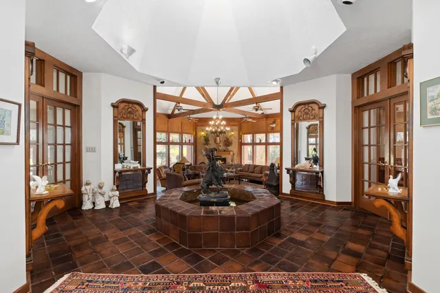 a living room with furniture ceiling fan and a large window