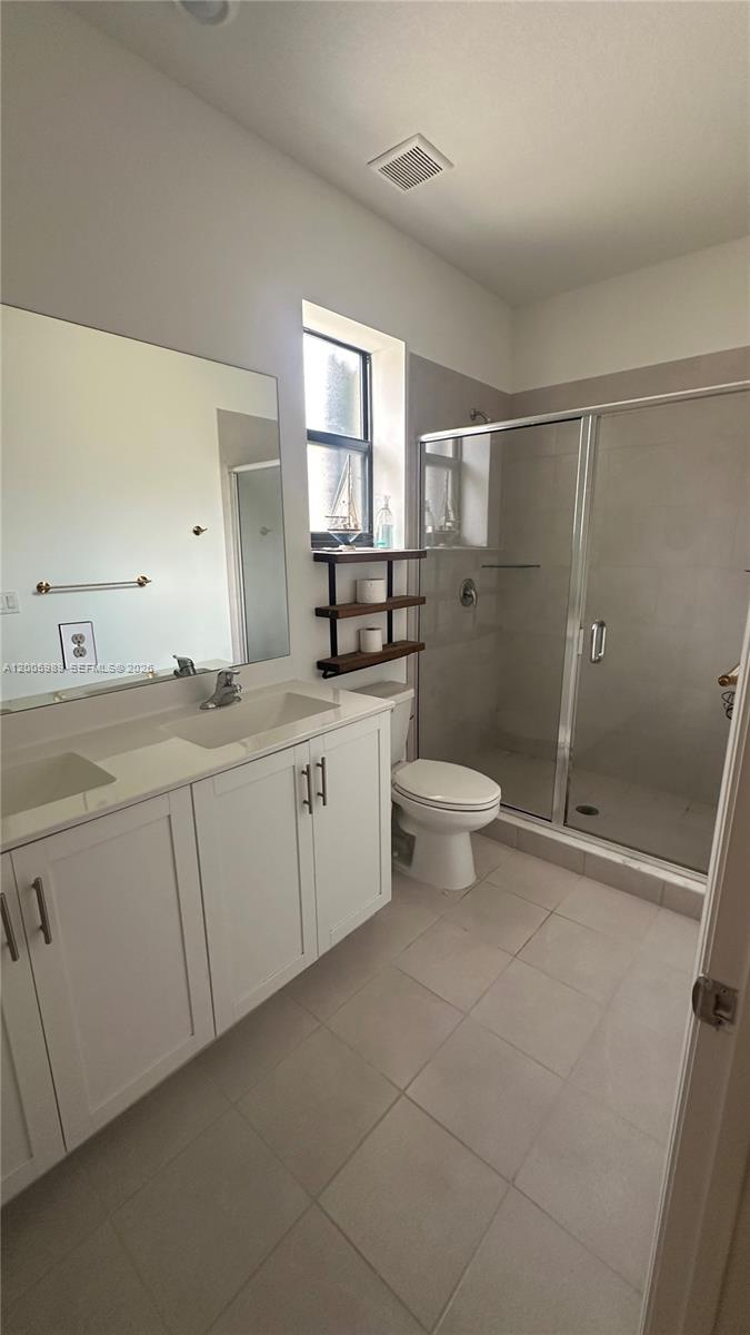 3423 West 110th Street Hialeah, FL 33018 - Photo 19 of 42 a bathroom with a double vanity sink and a toilet