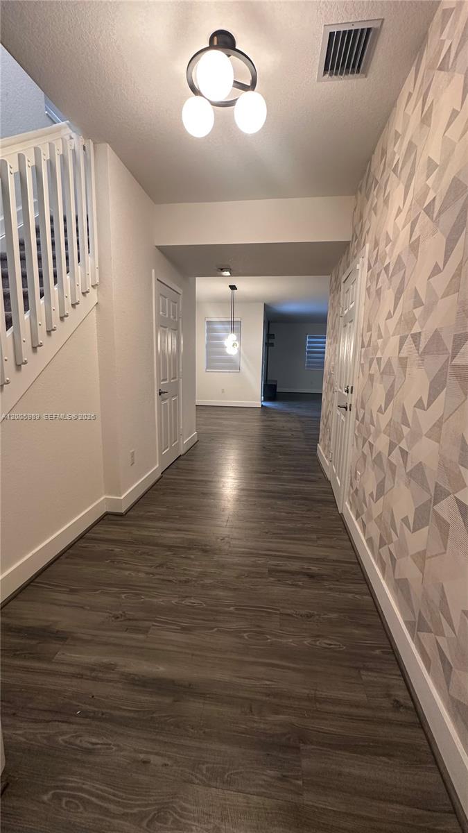 3423 West 110th Street Hialeah, FL 33018 - Photo 2 of 42 wooden floor in an empty room with a window