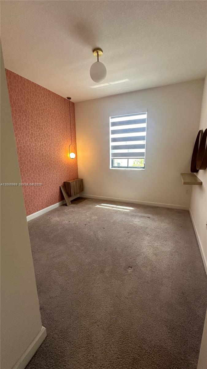 3423 West 110th Street Hialeah, FL 33018 - Photo 22 of 42 a view of an empty room with a window