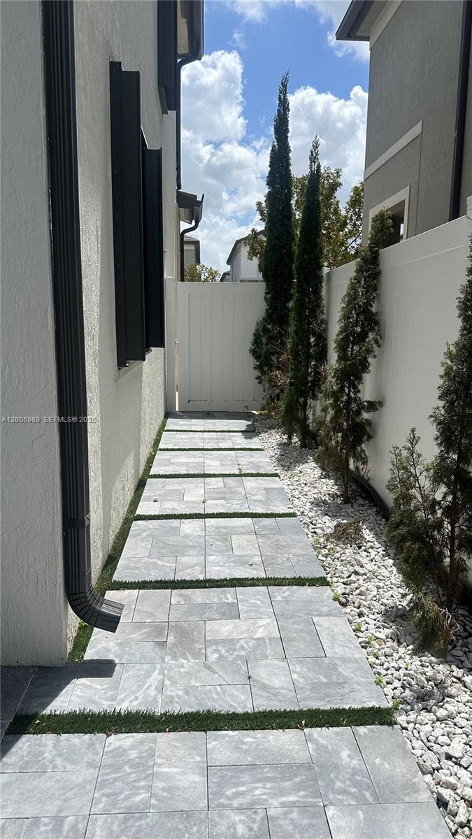 3423 West 110th Street Hialeah, FL 33018 - Photo 32 of 42 a view of a pathway both side of the house
