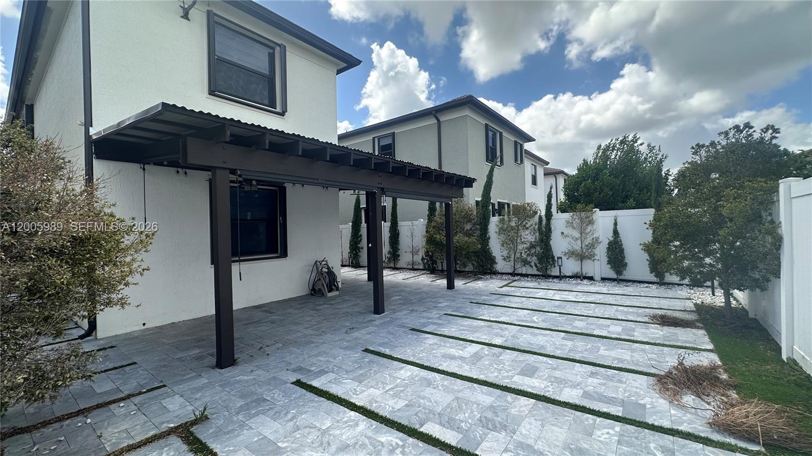3423 West 110th Street Hialeah, FL 33018 - Photo 33 of 42 a front view of a house with a garden and trees
