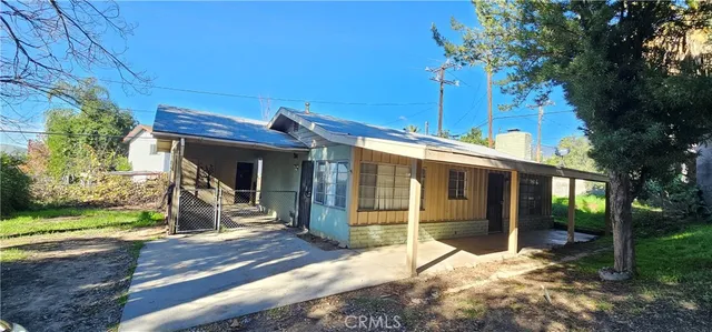 a view of a house with backyard porch and sitting area