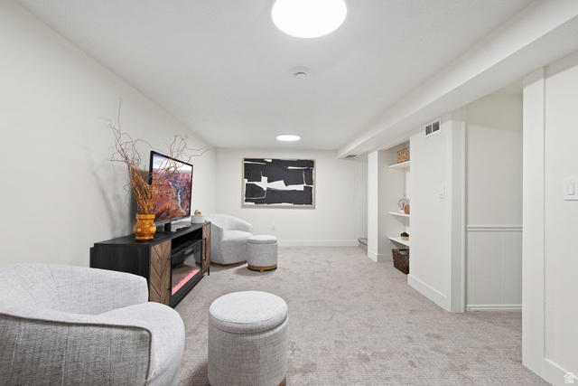 673 East 700 South Springville, UT 84663 - Photo 26 of 43 Recessed lighting illuminating a carpeted entertainment area with built-in shelving, wainscoting, and a window